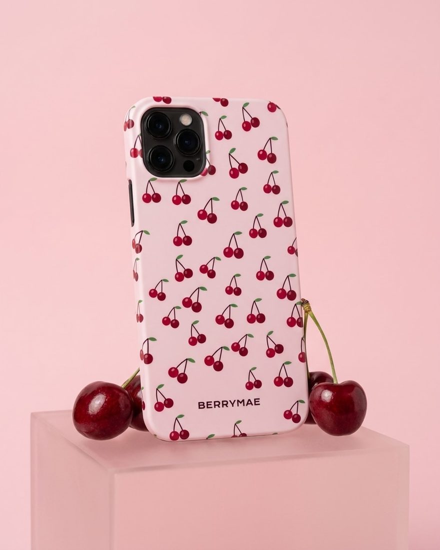 A BerryMae social post showing a cherry print phone case on a pink plinth